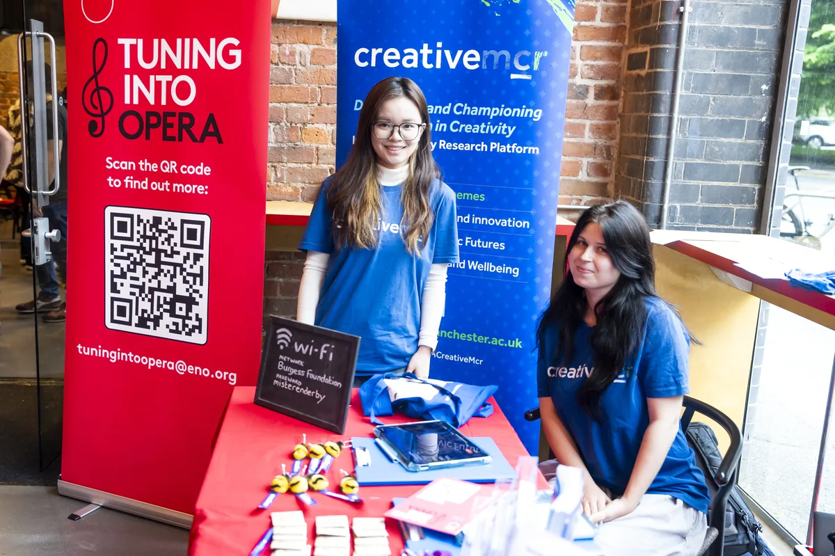Registration desk with ENO Tuning Into Opera and Creative Manchester branding