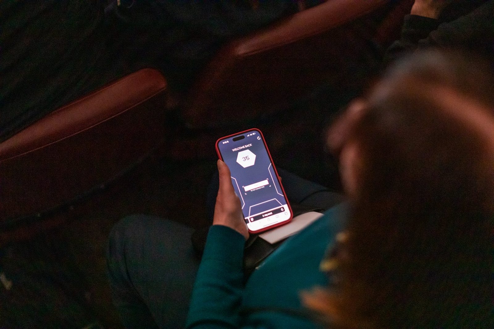 Audience members taking part on their phones during the performance